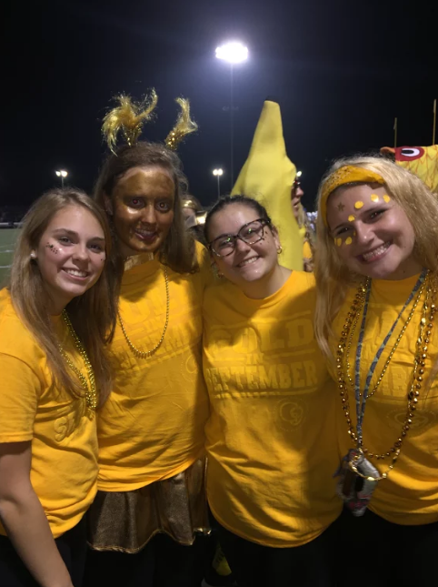 Students wearing their gold in support of G9 at the Arrowhead football game on September 16th.