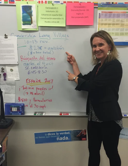 Amy Coraggio points at the information for Concordia Language Village on September 22, 2016 in her classroom at North Campus to encourage students to join the trip.