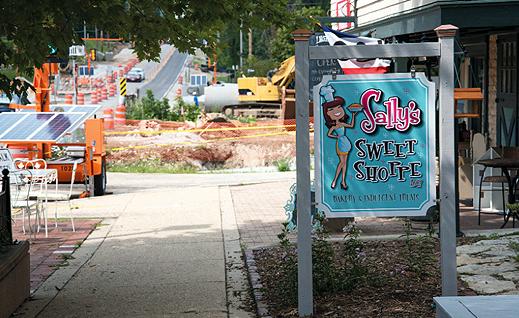 Sallys Sweet Shoppe Sign in front of construction on Genesee Street