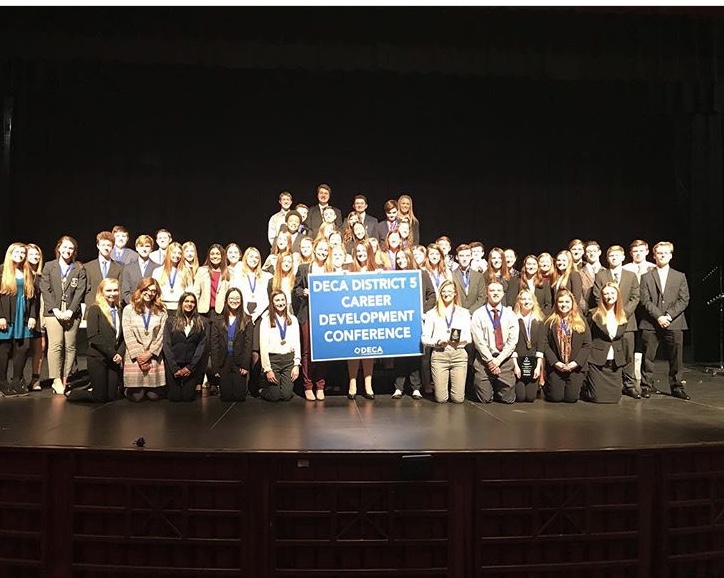 Arrowhead DECA students holding their medals and trophies after DECA districts competition 
